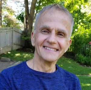 Photo of JD Grant standing in a green yard.